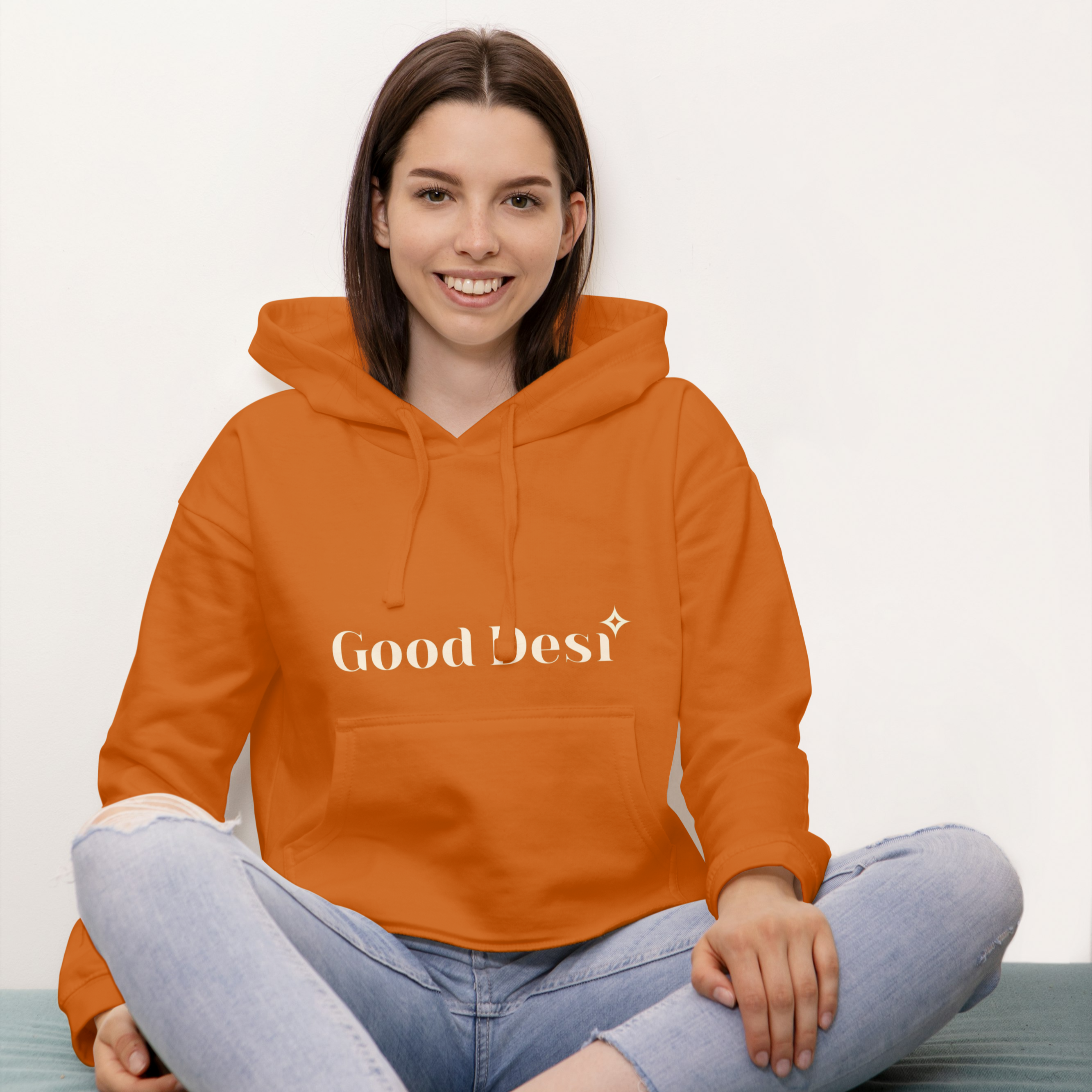 Person wearing an orange hoodie with 'Good Best' text on a white background